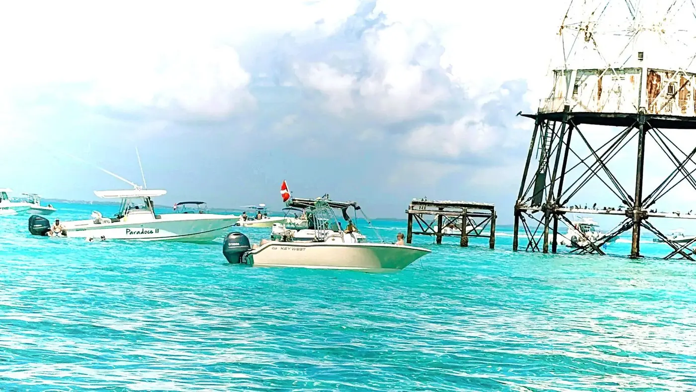 Alligator Reef Lighthouse with rental boats anchored at the reef
